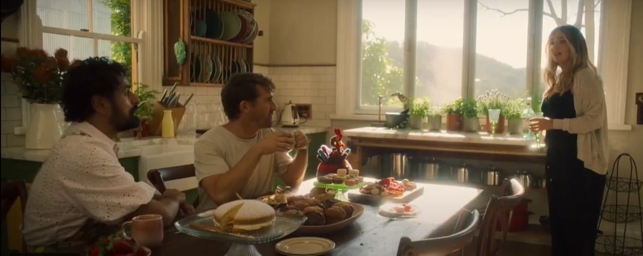 Two man and a women in a country styled kitchen